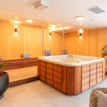 Relaxing spa area at Rawhiti Estate retirement village with wooden hot tub and cozy seating.