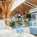 Atrium at Rawhiti Estate Retirement Village, two comfortable couches for relaxing and a coffee table with flowers.