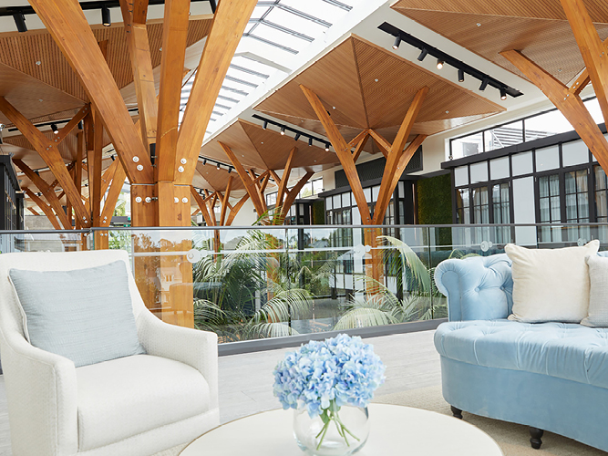 Atrium at Rawhiti Estate Retirement Village, two comfortable couches for relaxing and a coffee table with flowers.